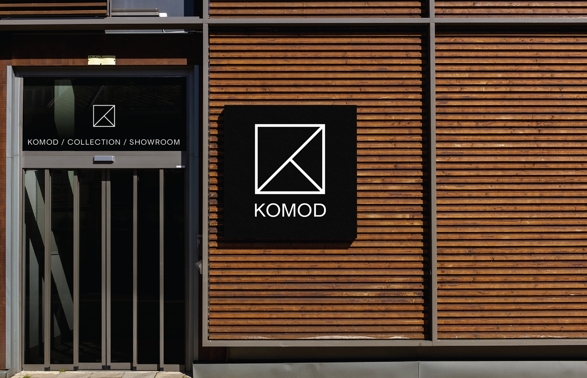 Komod logo mockup displayed on a store front sign.